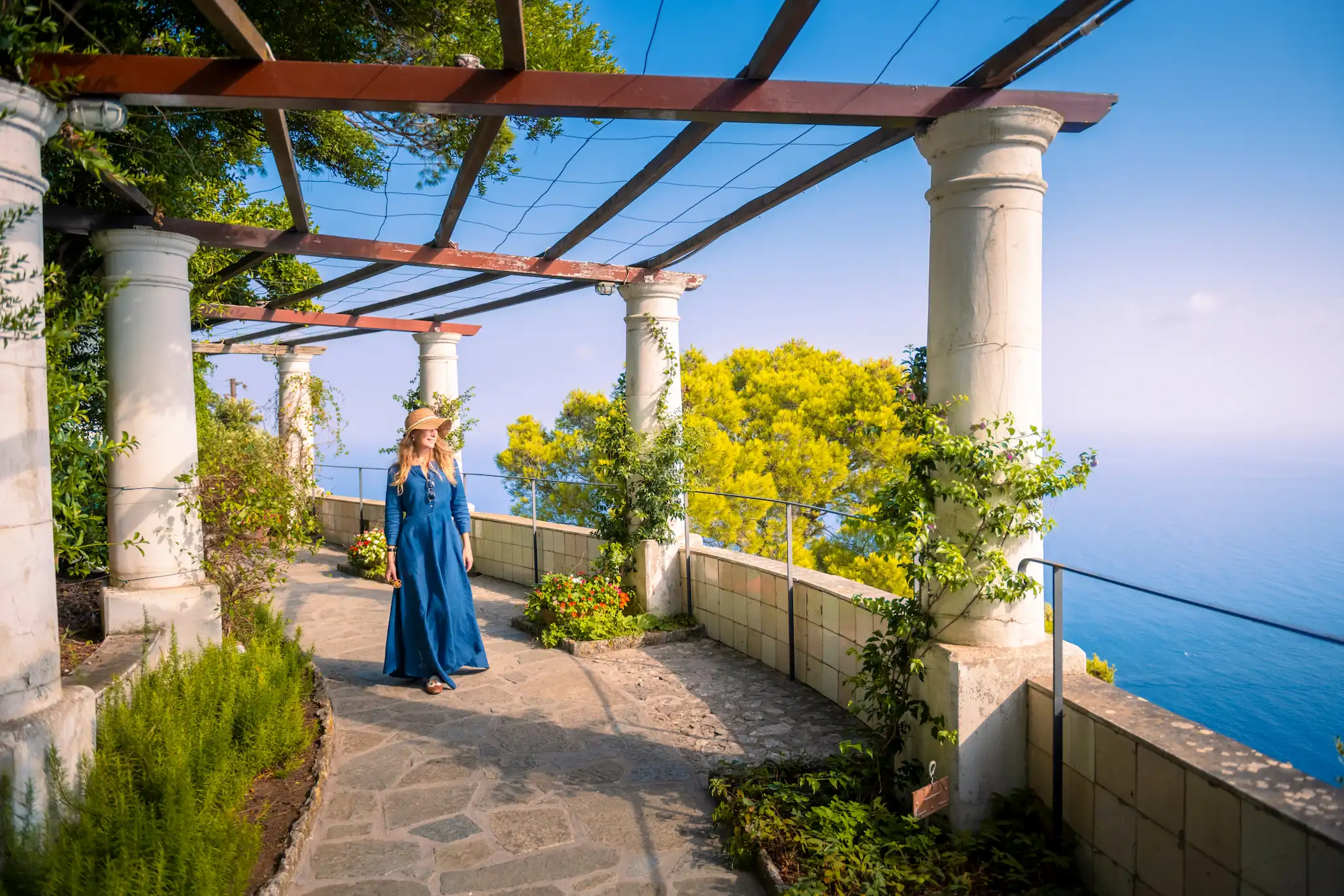 A girl walking into a park in Capri island.